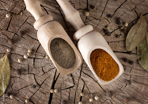 photoof different types of hot pepper and bay leaves as a spice for food on a wooden table photo