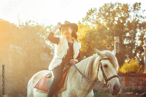 woman on horse in hat