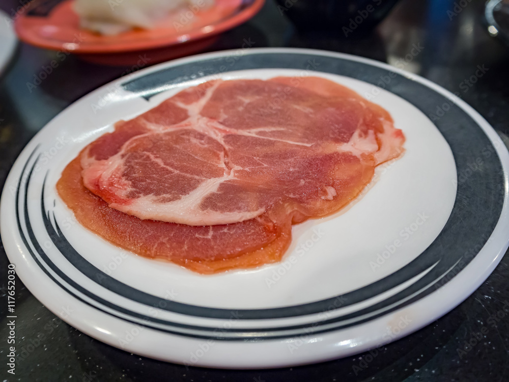 Pork on plates for suiyaki or shabu-shabu, shallow DOF, selective focus