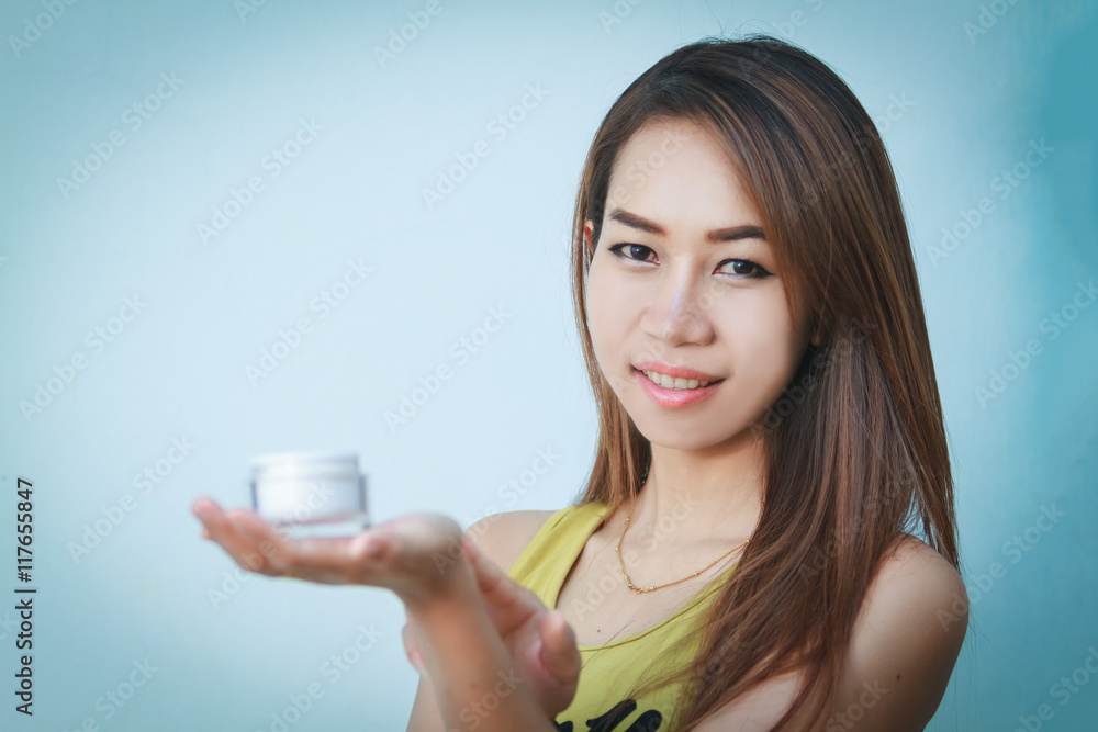 A beautiful woman asian using a skin care product, moisturizer o A beautiful woman asian using a skin care product, moisturizer o