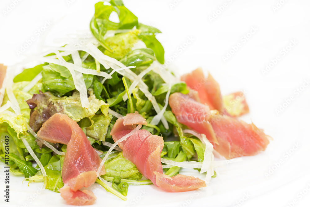 salad of arugula and tuna vegetables on a white background in the restaurant salad of arugula and tuna vegetables on a white background in the restaurant