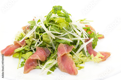 salad of arugula and tuna vegetables on a white background in the restaurant