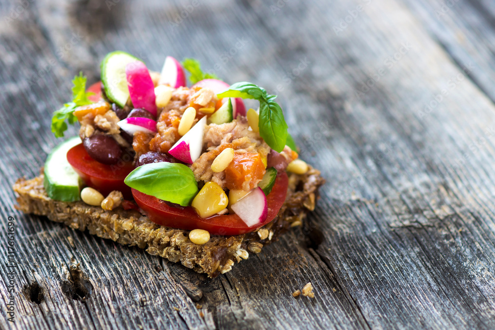 Delicious healthy sandwich with crunchy wholemeal bread on a wooden background Delicious healthy sandwich with crunchy wholemeal bread on a wooden background
