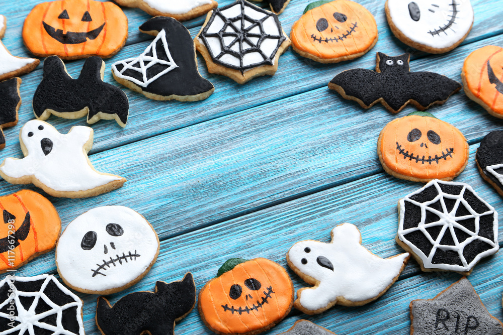 Fresh halloween gingerbread cookies on blue wooden table Fresh halloween gingerbread cookies on blue wooden table