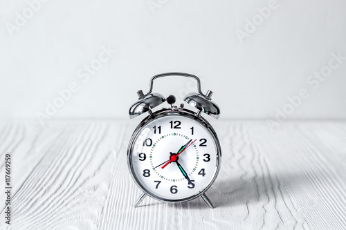 alarm clock at empty locker on white background