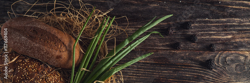 Drown bread with seeds with biscuits on the table with leek and