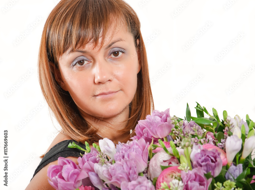 Cute Mature woman with a bouquet of flowers in purple tones Cute Mature woman with a bouquet of flowers in purple tones
