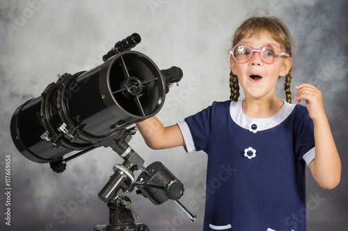 Wallpaper Mural Girl astronomer happily surprised by what he saw in the telescope