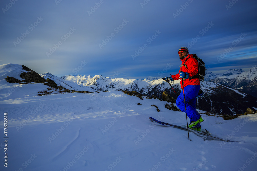 Ski tour - skier climbing to the top
