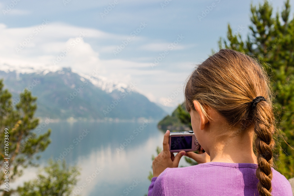 Girl taking photo with compact camera