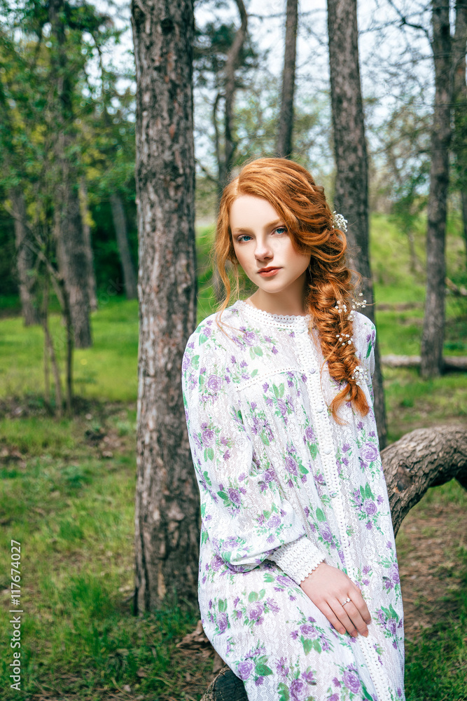 Portrait of a beautiful redhead girl in the spring garden Portrait of a beautiful redhead girl in the spring garden