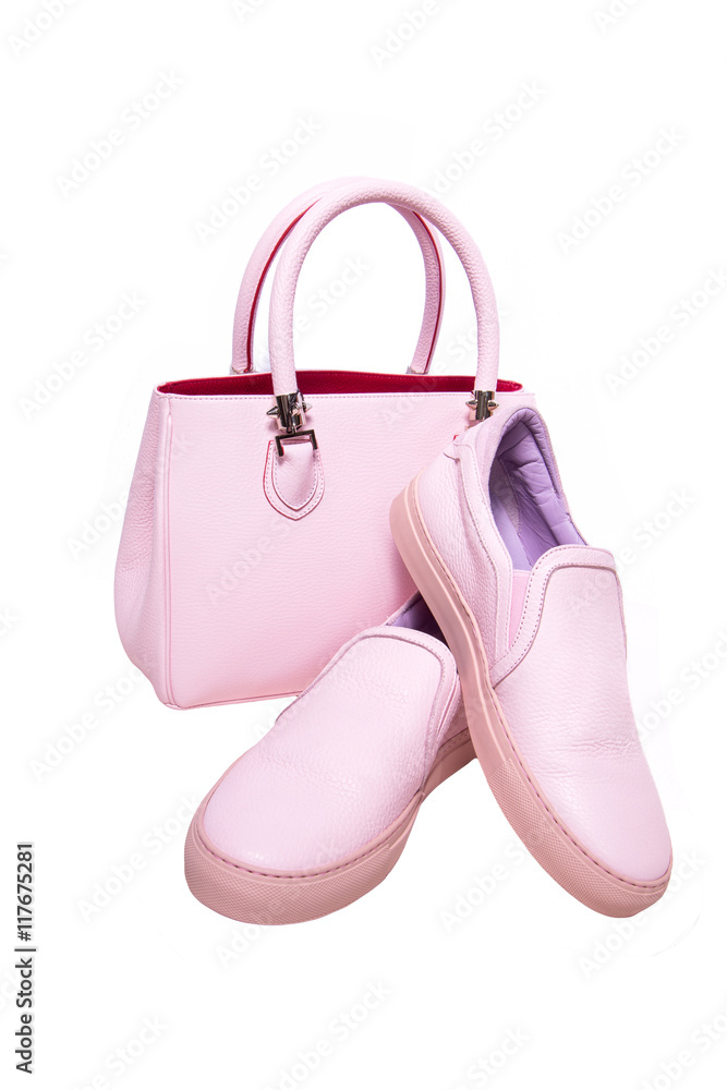 Pair of pink women's shoes with handbag isolated on a white