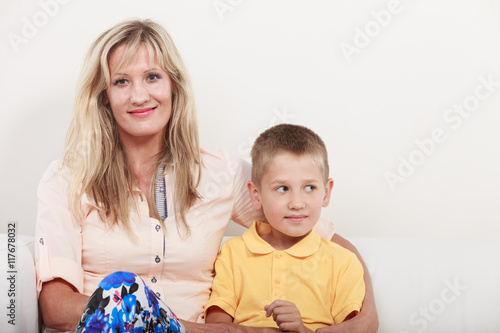 Happy family. Mother and kid on sofa at home.