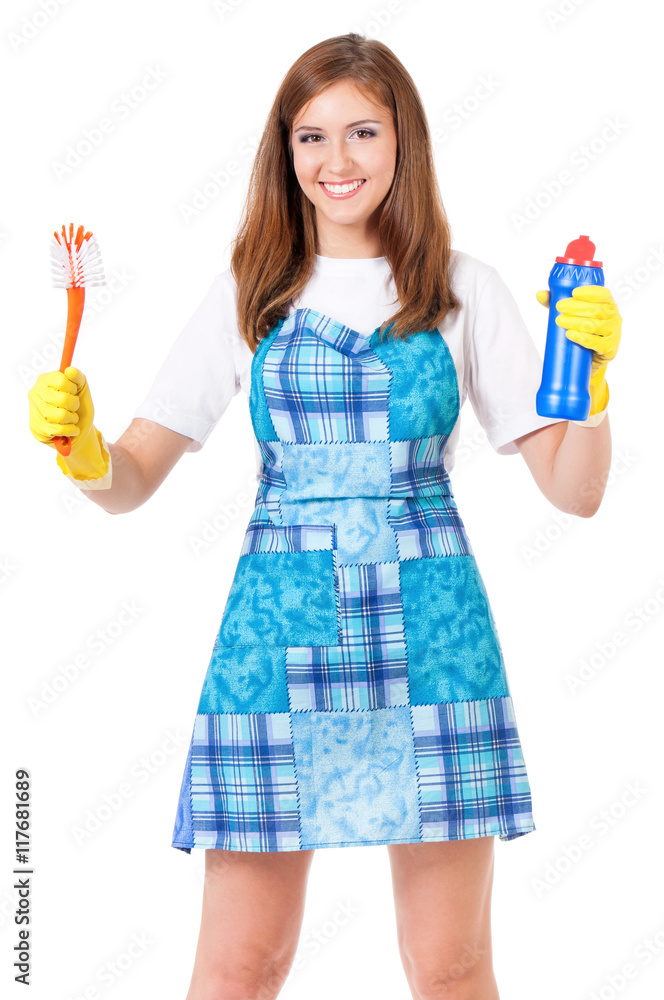 Smiling young woman holding bottle of chemistry for cleaning house. Cleaning concept. Beautiful happy girl with cleaning tools and products on white background. Housekeeper isolated portrait. Smiling young woman holding bottle of chemistry for cleaning house. Cleaning concept. Beautiful happy girl with cleaning tools and products on white background. Housekeeper isolated portrait.