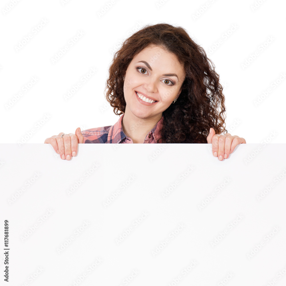 Portrait of a happy young casual woman holding a blank signboard, isolated on white background. Closeup portrait of a beautiful brunette teen hiding behind empty white sign. Portrait of a happy young casual woman holding a blank signboard, isolated on white background. Closeup portrait of a beautiful brunette teen hiding behind empty white sign.