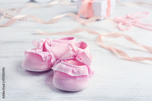 Beautiful composition with baby booties on wooden background