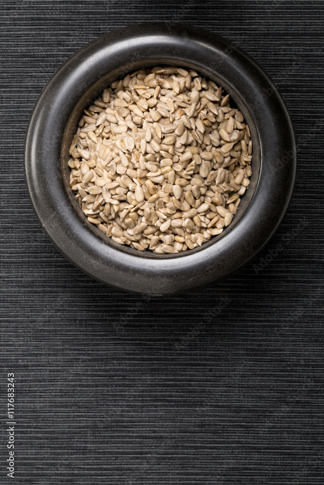 Shelled sunflower seeds in black mortar Shelled sunflower seeds in black mortar