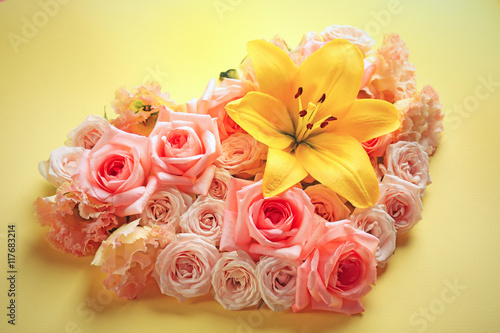 Heart shaped roses on yellow background