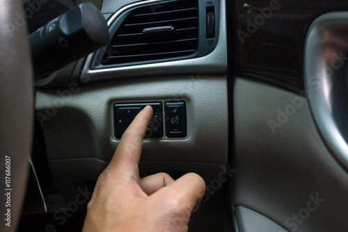 man hand use the signal switch. Car interior detail © oopoontongoo