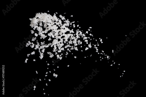Salt flying in the air isolated on black background , stop motio