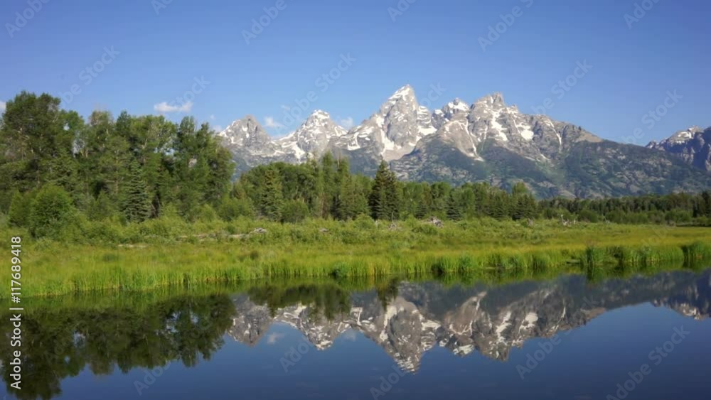 The water is perfectly smooth showing high peak reflections in the Teton's The water is perfectly smooth showing high peak reflections in the Teton's