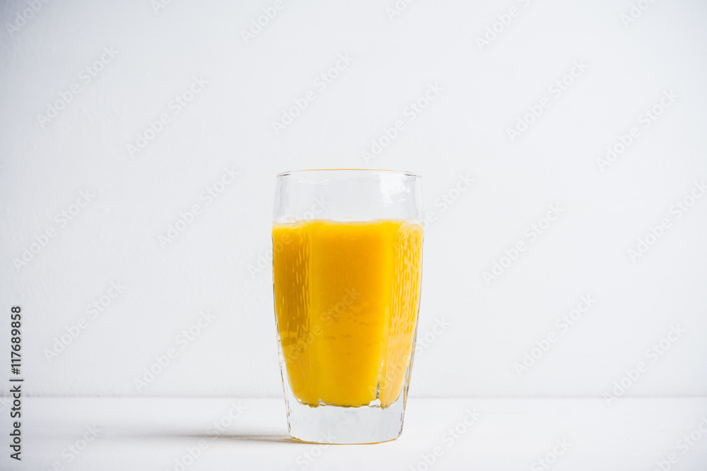 Glass of fresh orange juice on the white wooden background Glass of fresh orange juice on the white wooden background