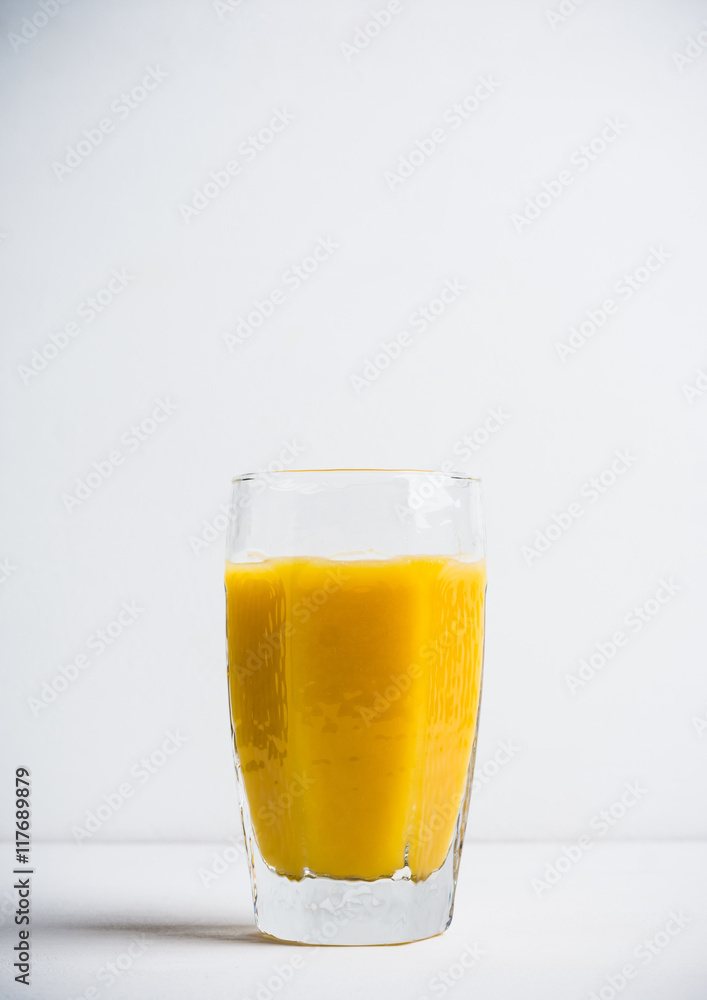 Glass of fresh orange juice on the white wooden background Glass of fresh orange juice on the white wooden background