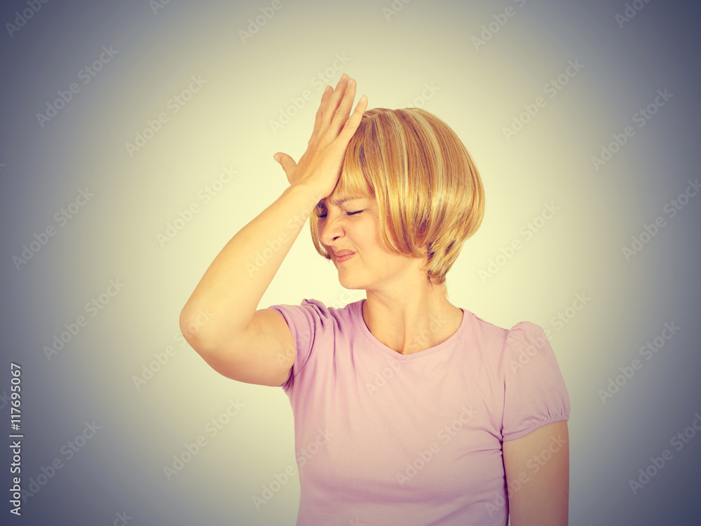 Witless young woman holding her hand to her forehead