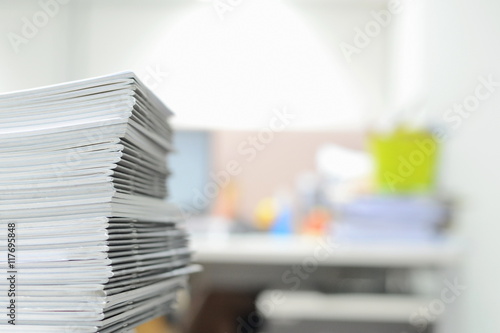 Stack of business reports on desk with copy space for text at right side,high key tone.