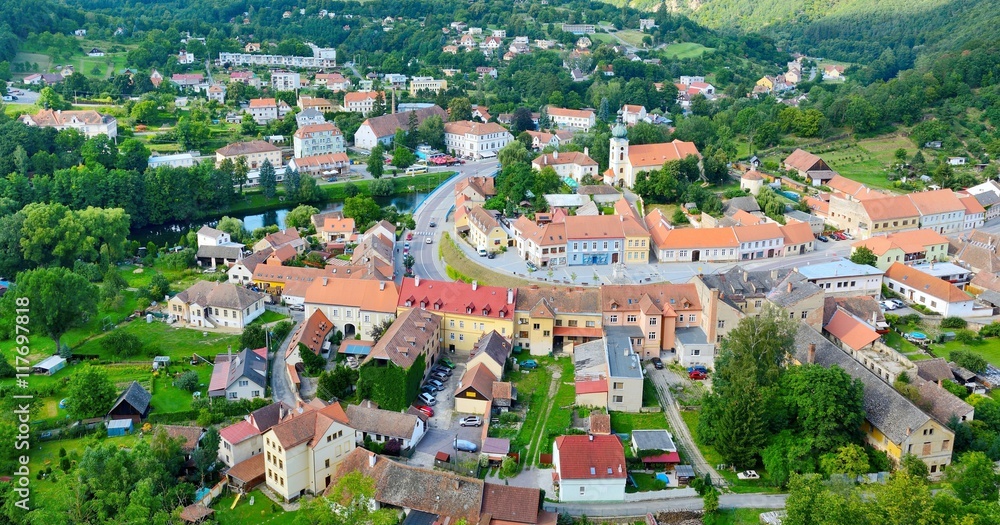 View of the Vranov nad Dyji village from the top of the hill. View of the village centre with many small houses, parked cars, river Thaya and major street.