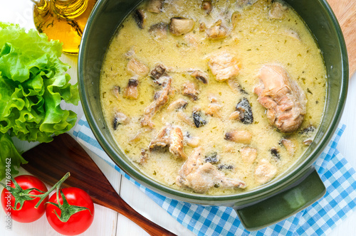 Fricassee of chicken with mushrooms in ceramic pot