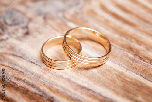 Two beautiful wedding rings on white background, close up
