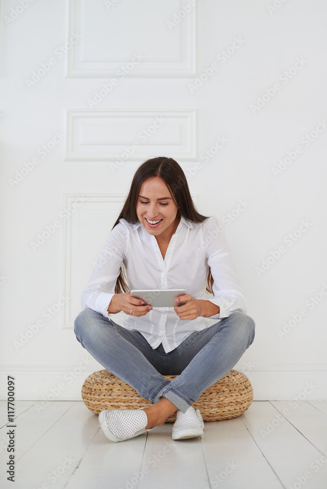 Modern young businesswoman using her tablet with joyful facial e Modern young businesswoman using her tablet with joyful facial e
