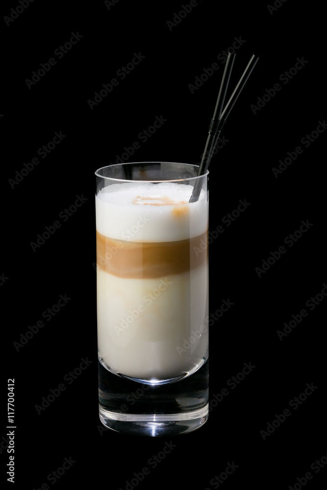 Iced coffee in a glass with a straw. On a black background Iced coffee in a glass with a straw. On a black background
