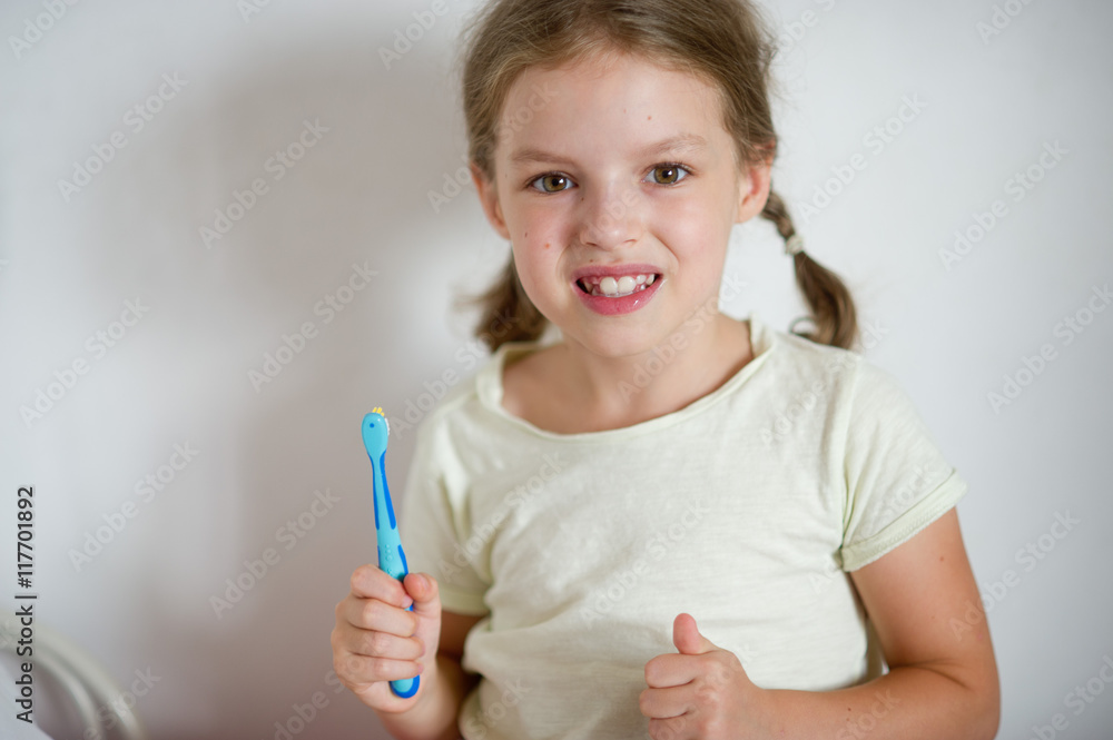 Cute little girl with pigtails diligently brushing his teeth. Cute little girl with pigtails diligently brushing his teeth.