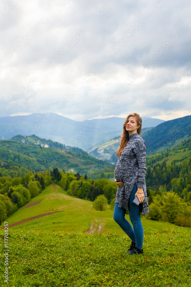 Beautiful view from mountain with pregnant woman on the foregrou