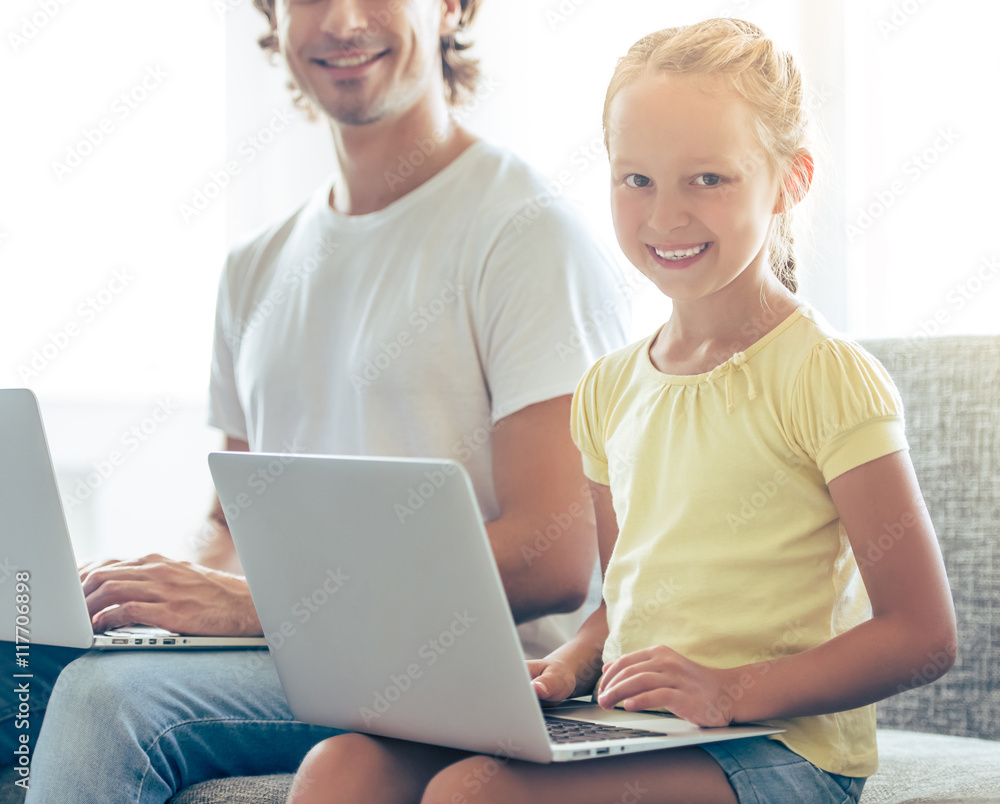 Father and daughter with gadget Father and daughter with gadget
