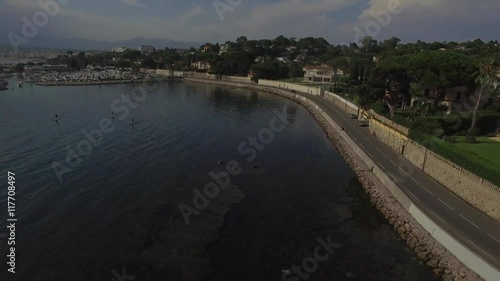 Wallpaper Mural 4K Stand up paddle board surfers move in Nice city coastal waters of French Riviera Mediterranean sea coastline in south of France. Active lifestyle urban conditions water sports tourism. Coastal road Torontodigital.ca