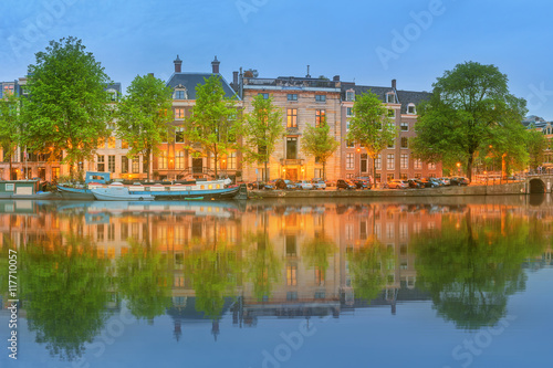 Panoramic view and cityscape of Amsterdam with boats  old buildings and Amstel river  Holland  Netherlands