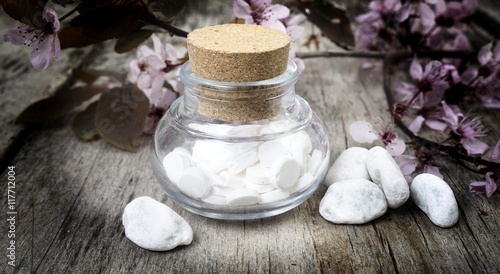 Schuessler Salze auf atem Tisch mit Kirschblüten photo