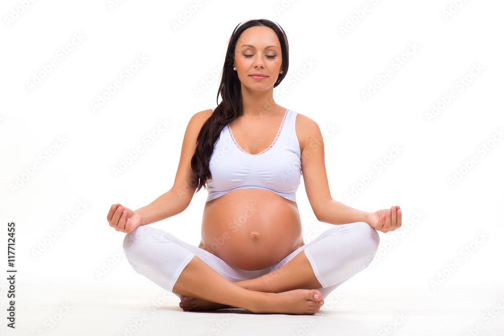 Relaxation and meditation during pregnancy. Young pregnant woman doing yoga