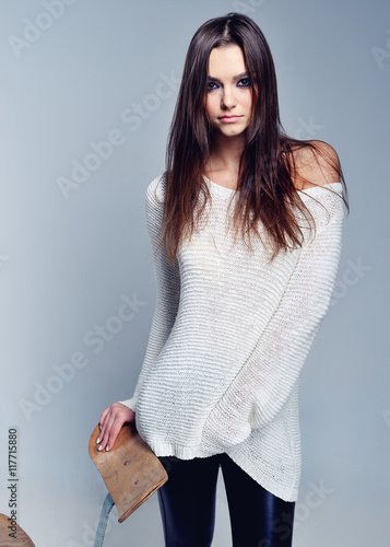 Pretty brunette covering herself in a warm sweater