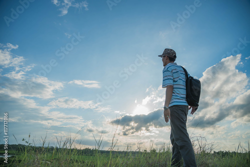 man travelling in nature with backpack