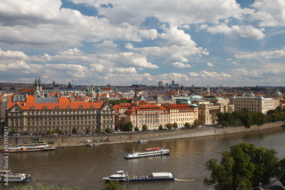 Naklejka premium Pleasure boats on the Vltava river near embankment Dvorak. Prague