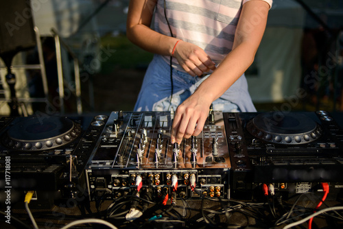 Club, disco DJ playing and mixing music for crowd of happy people. Nightlife, concert lights, flares