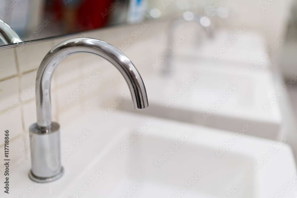 Modern water faucet in toilet, depth of field effect Modern water faucet in toilet, depth of field effect