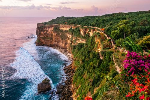 Scenic landscape of high cliff with fantastic sunset sky at Uluwatu . Travel Bali, Indonesia photo