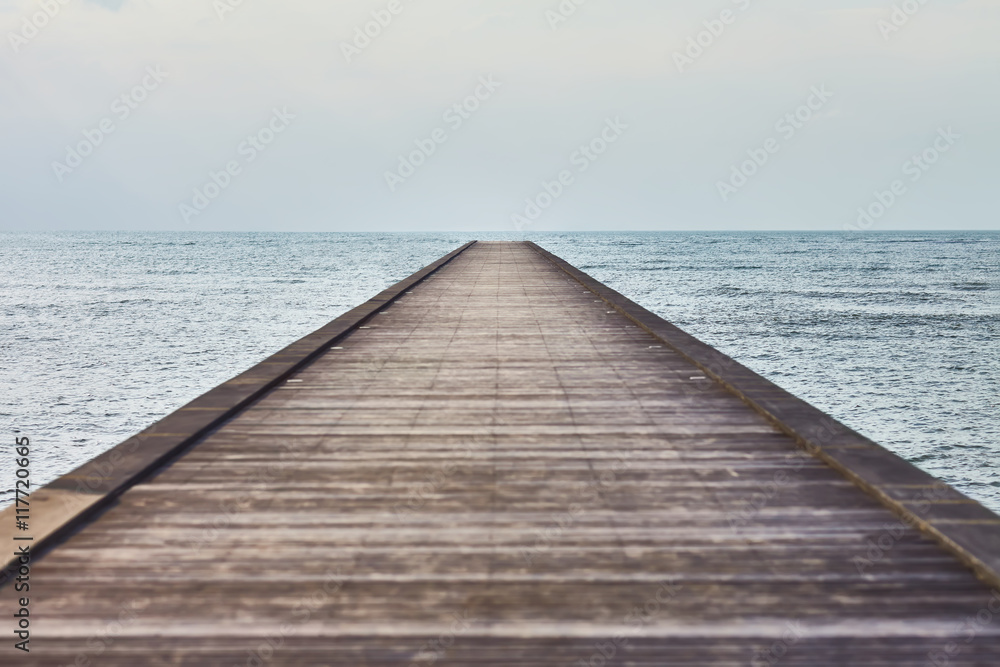 Perspective view of a wooden pier in tropical sea