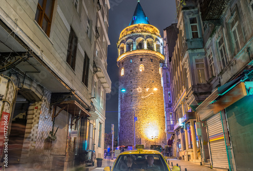Magnificence of Galata Tower at night with taxi on the street, I