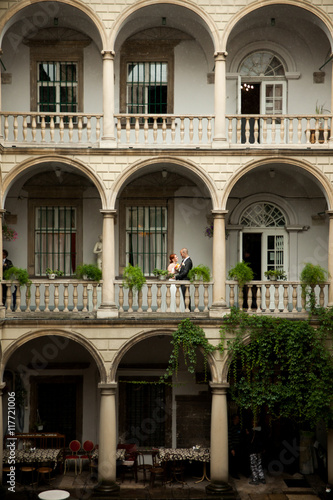 A look from a far on the wedding couple posing on the Italian ba